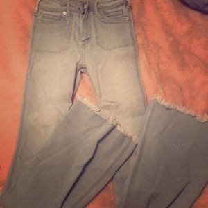 light wash denim flare jeans with frayed edges